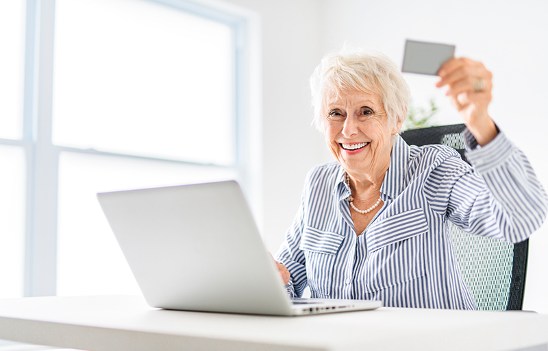 senior women using a laptop while sitting at the office