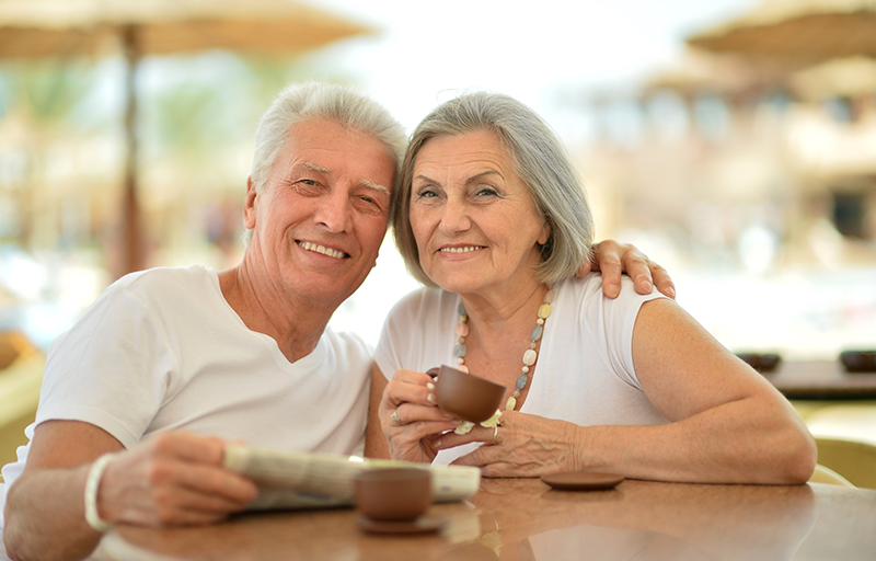 Nice senior couple with coffee on vacation